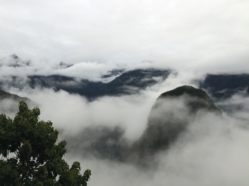 Just outside the entrance, foggy Machu Picchu
